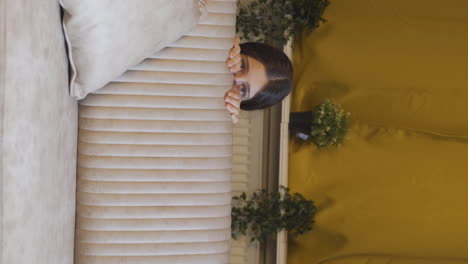 Vertical-video-of-The-young-woman-hiding-from-fear.